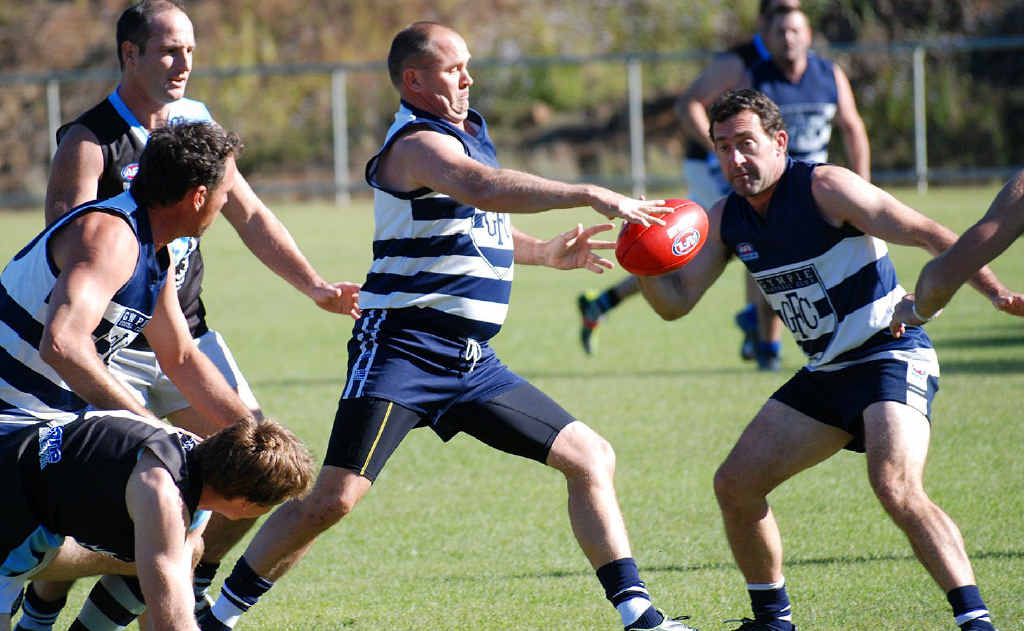 Coach Glenn Warren gets the ball away for the Cats. Coach Glenn Warren gets the ball away for the Cats.